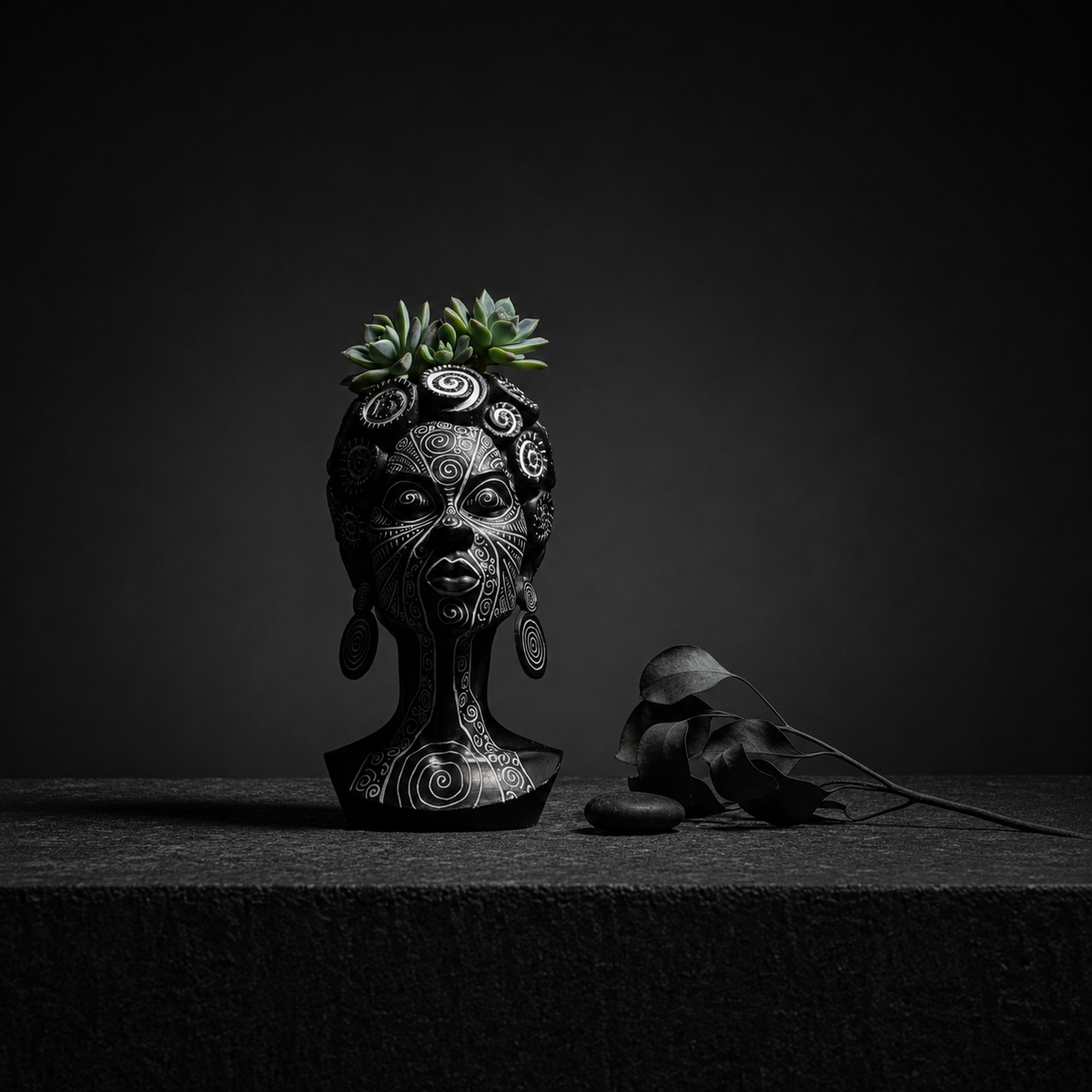 Spiral head planter with succulent and dried botanicals