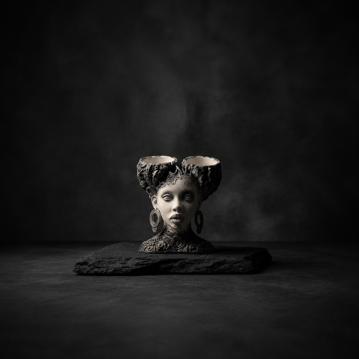 Black and ivory woman bust planter with twin baroque hair planting bowls on a dark backdrop