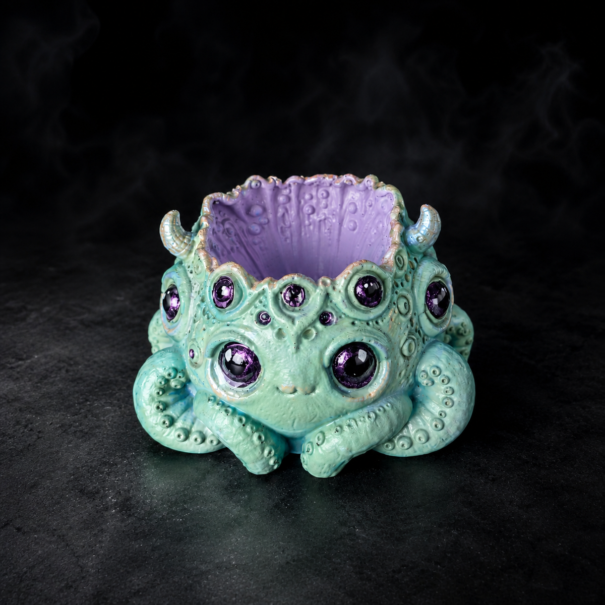 Noodle many eyed monster plant pot showing purple interior and tentacle detail