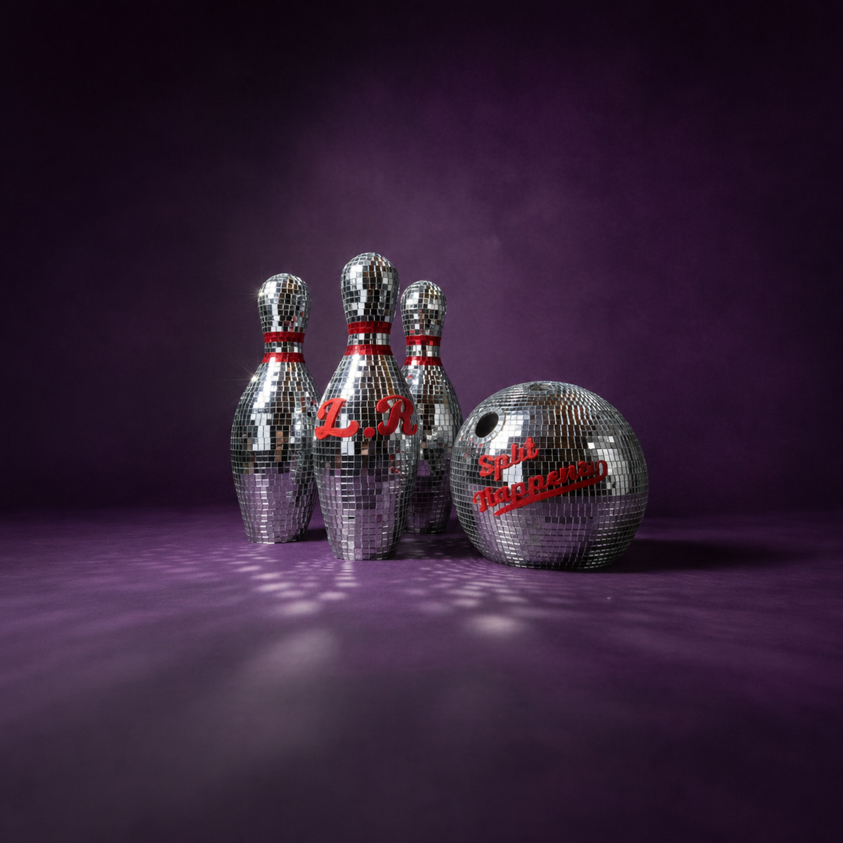 Personalised mirror bowling ball in front of three matching pins on a purple backdrop