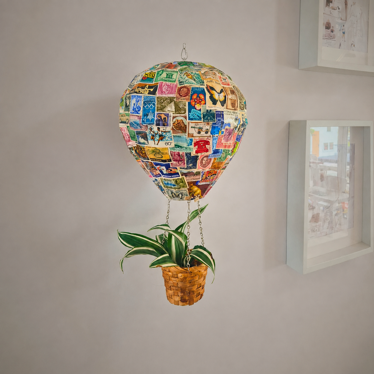 Vintage stamp hot air balloon planter hanging indoors with plant in basket