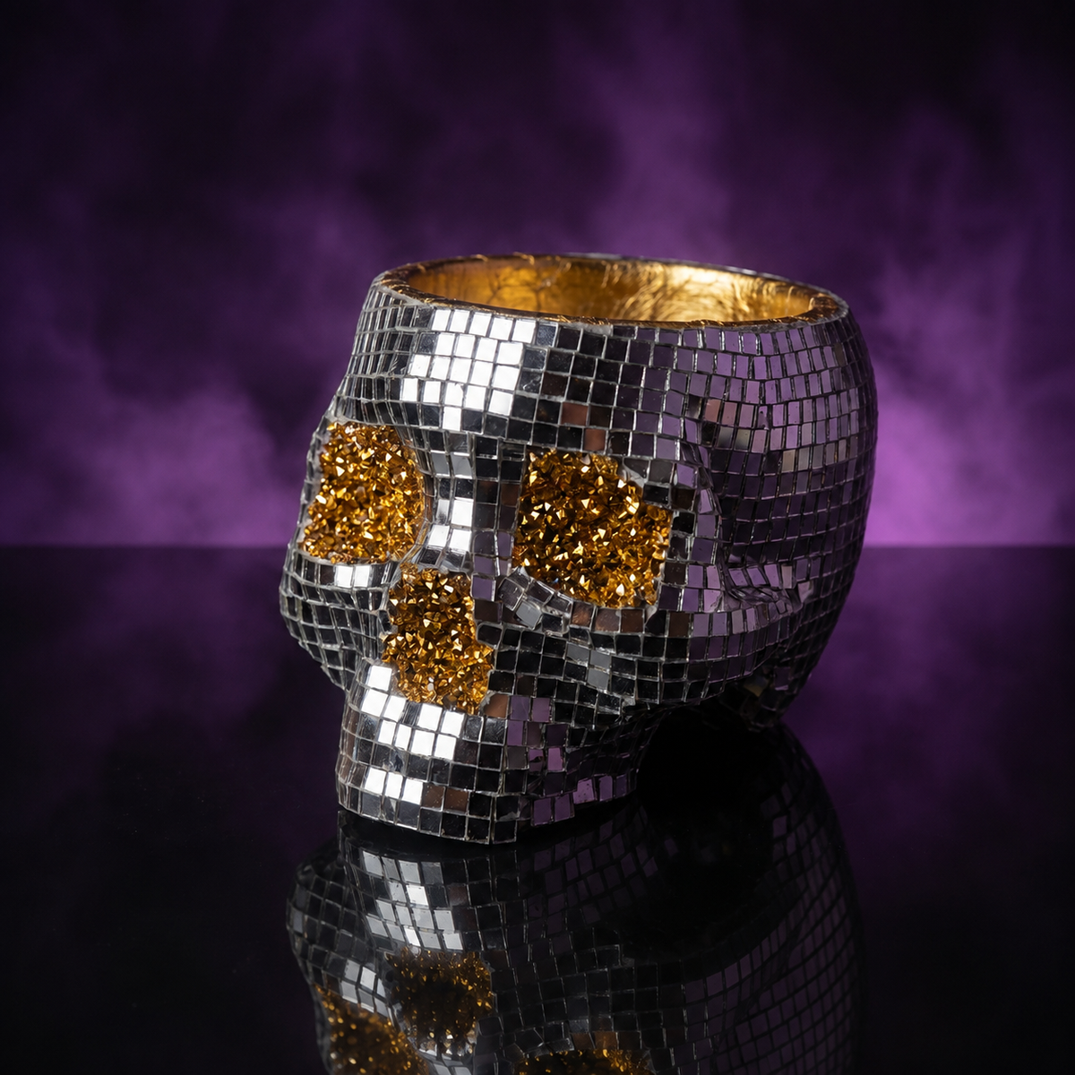 Three-quarter view of an unplanted disco skull planter on a smoky purple backdrop