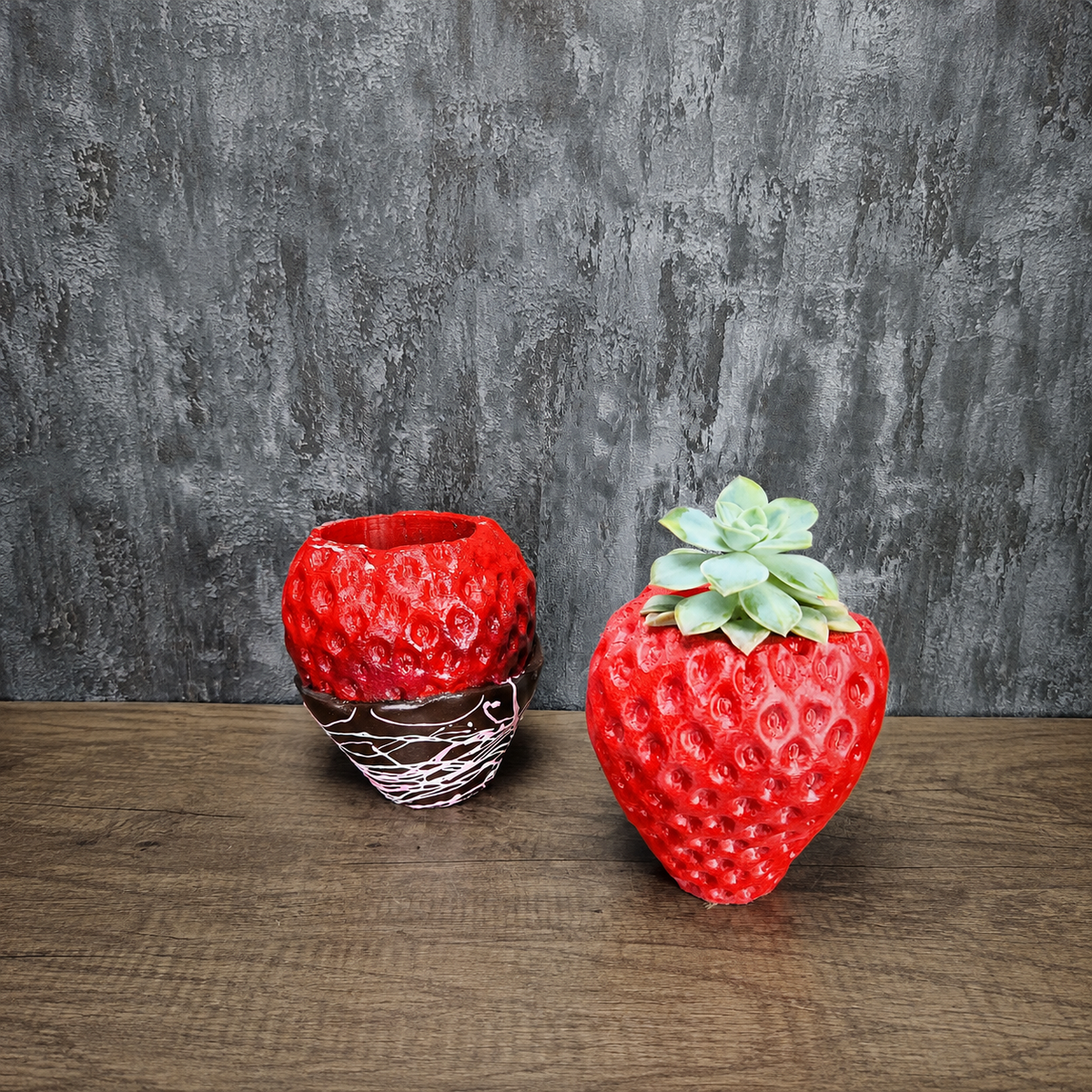 Red and chocolate-dipped strawberry planters displayed together