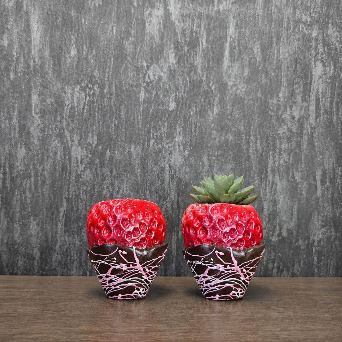 Unplanted chocolate-dipped strawberry planter with pink drizzle shown front-on