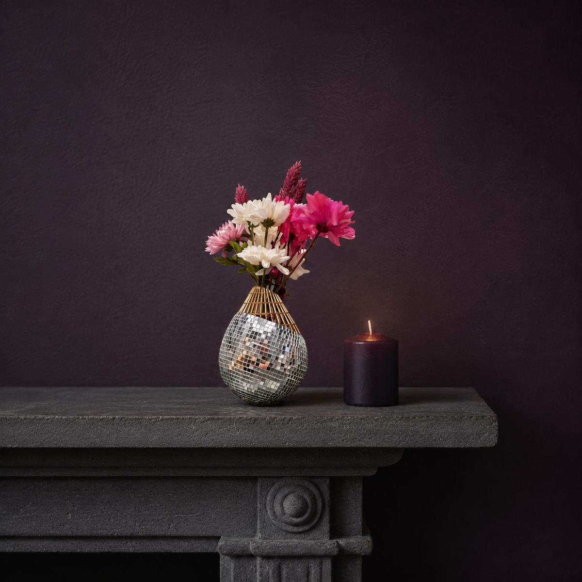 Mirror mosaic vase on mantelpiece with dried flowers