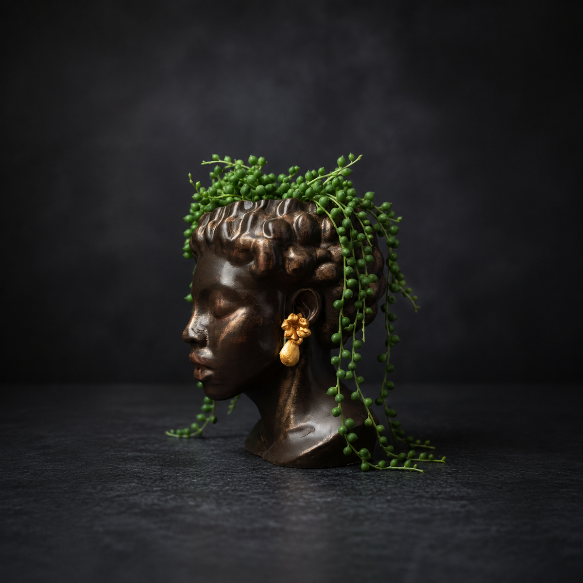 Bust planter with string of pearls trailing from the top