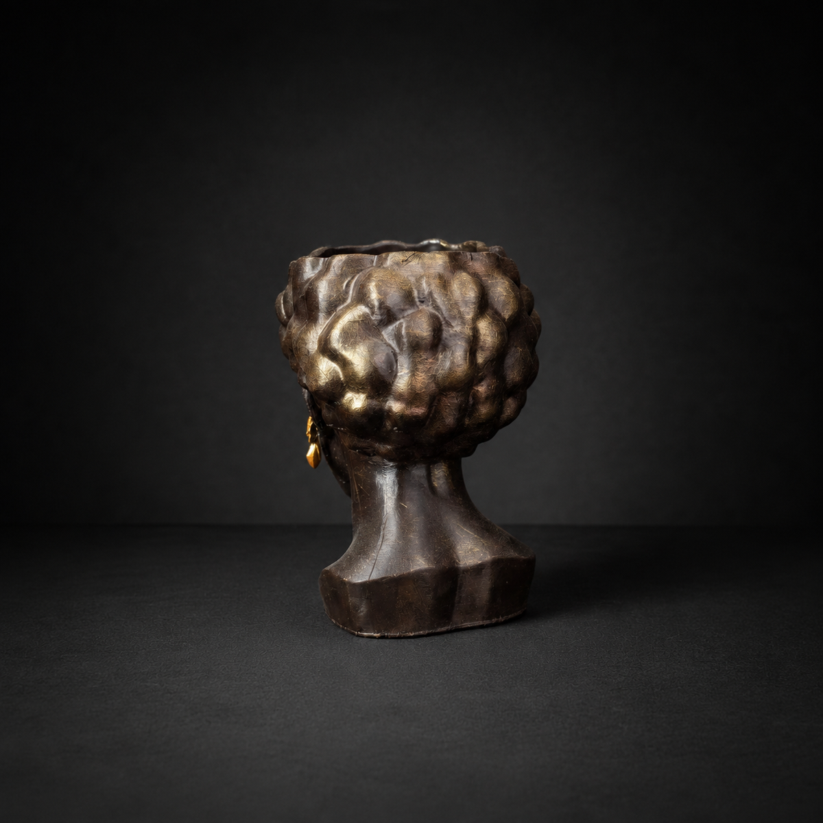 Cast stone head planter rear view showing sculpted hair detail
