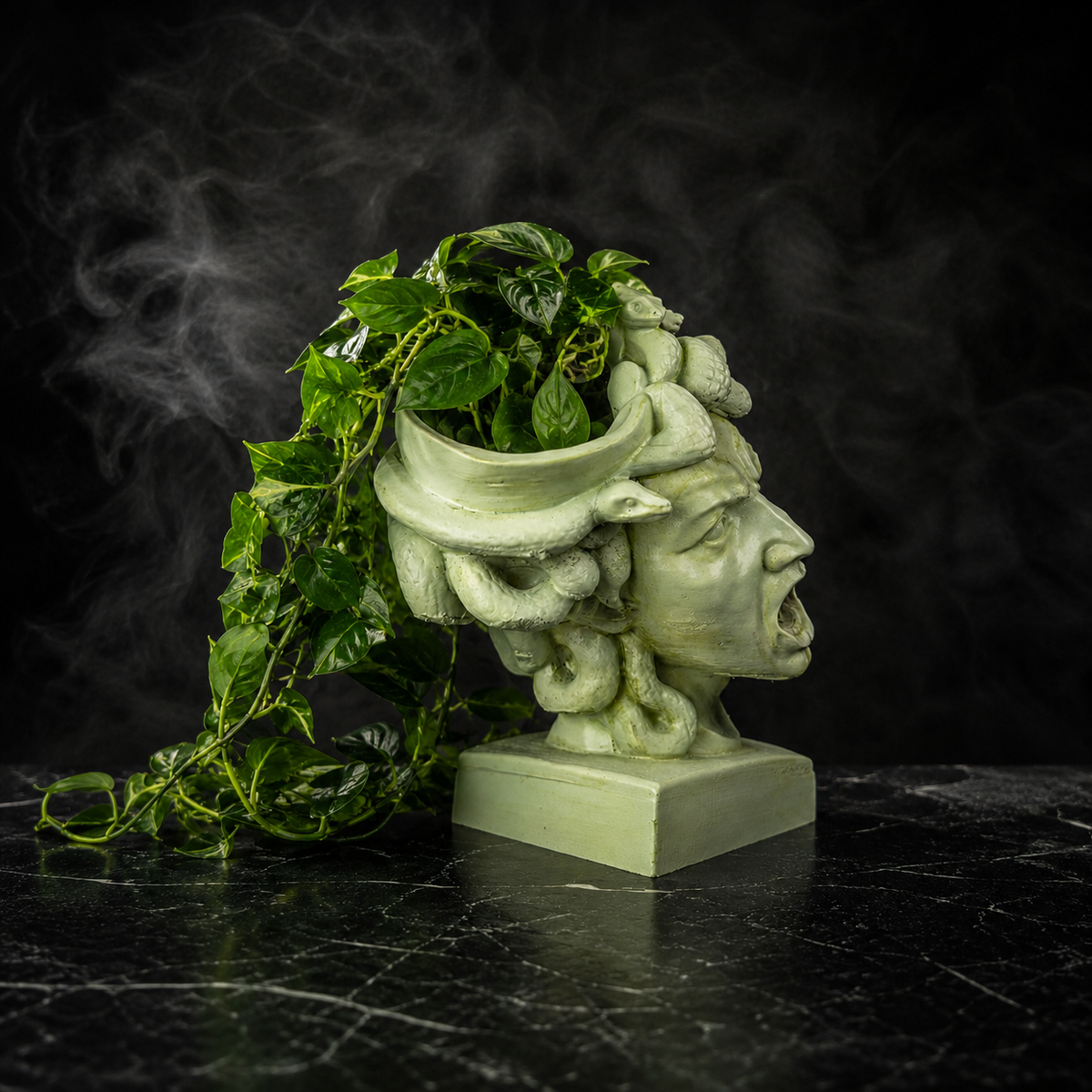 The Gorgon's Bloom Medusa cast stone planter with trailing green plant
