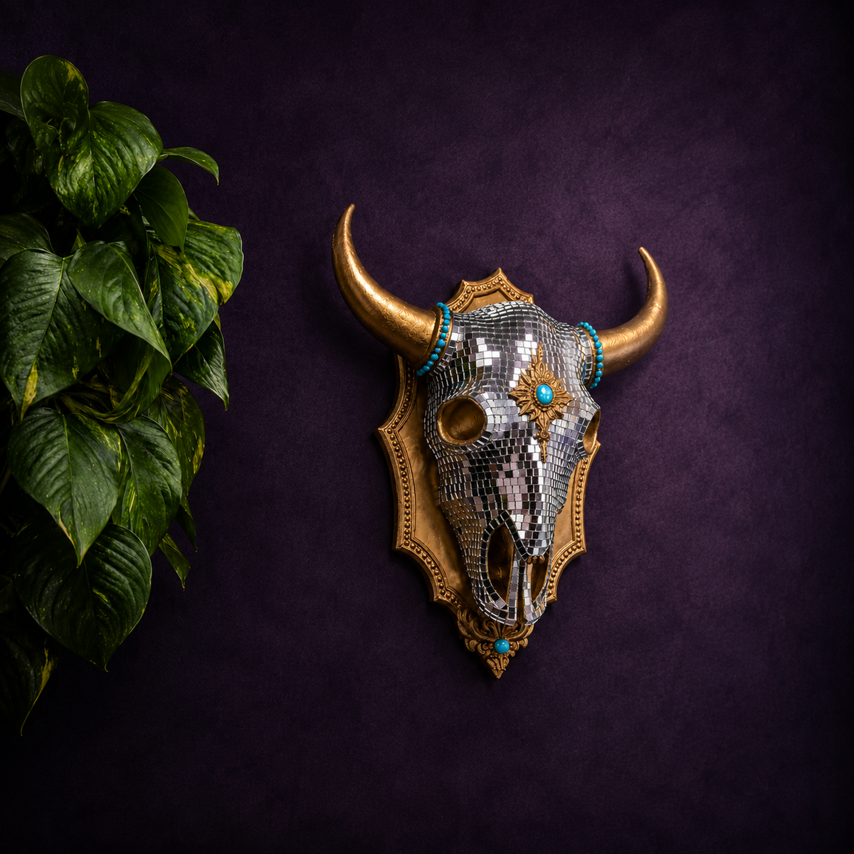 The Last Rodeo mirror ball bull skull wall art styled with green plant