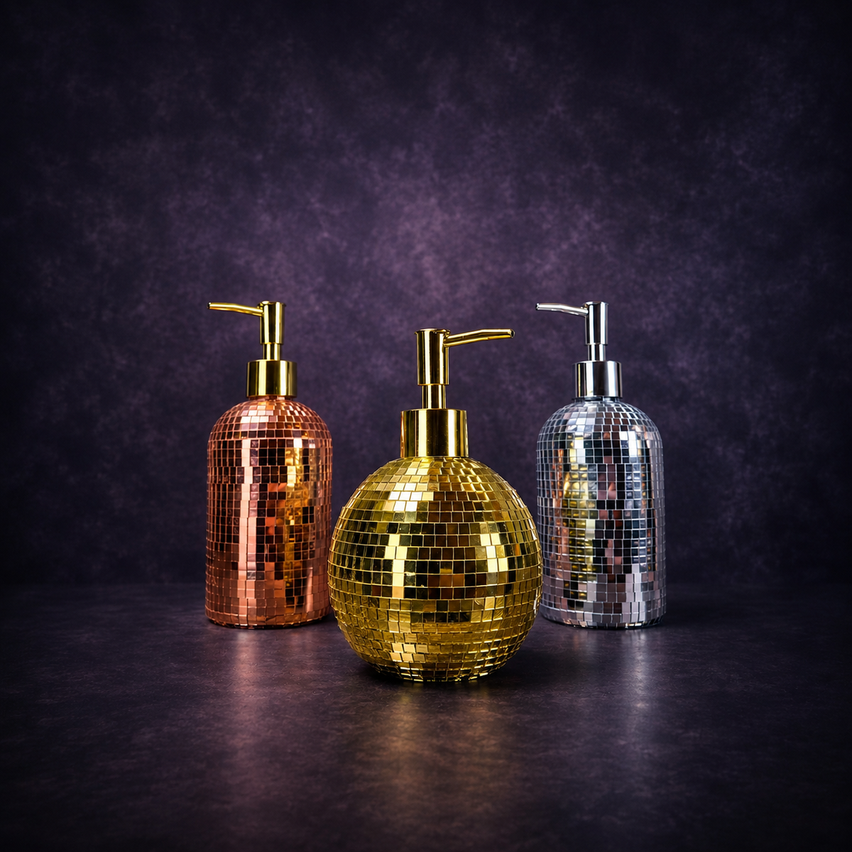 The Lather Ball mirror ball soap dispenser in gold on dark background
