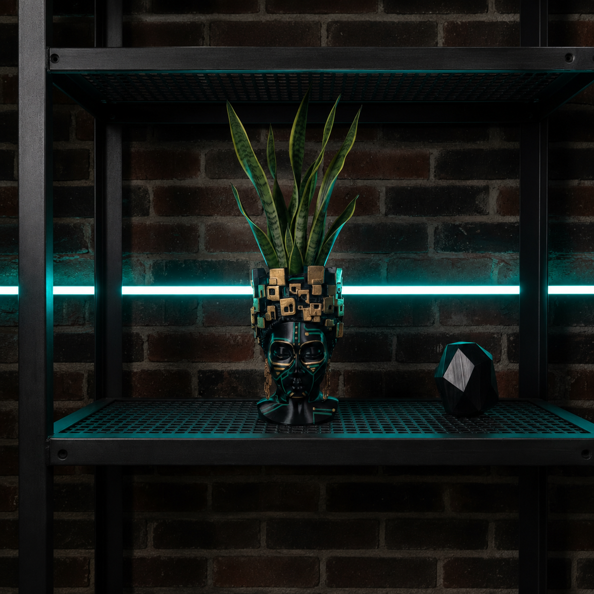 The Motherboard head planter with a snake plant on an industrial shelf