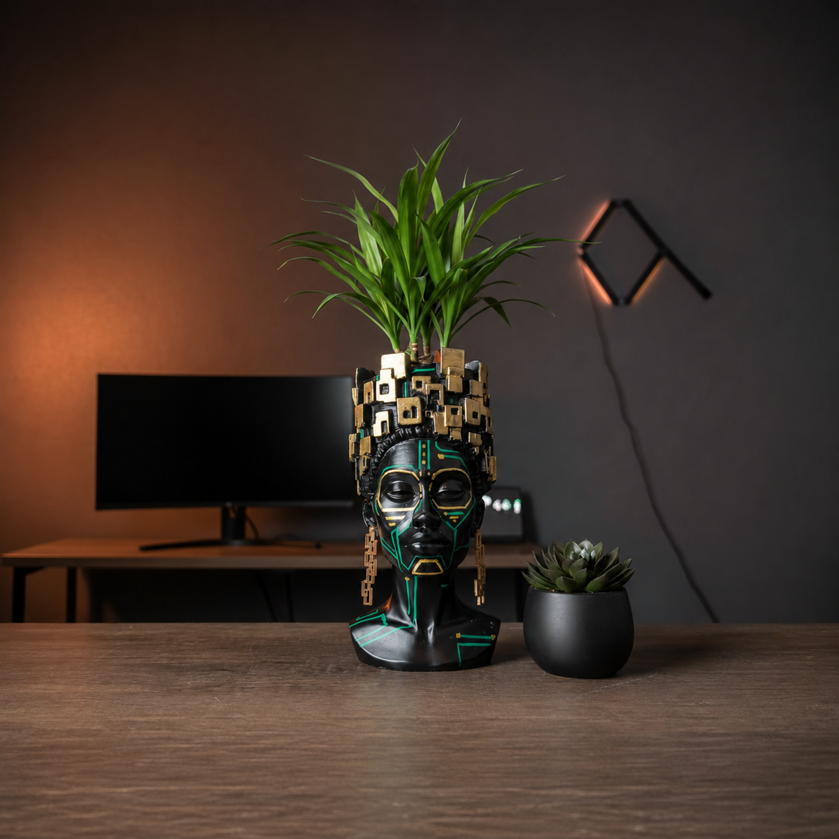 The Motherboard head planter with a dracaena on a home-office desk