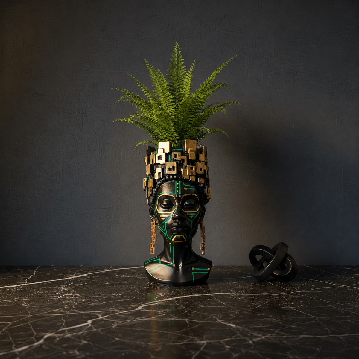 The Motherboard head planter with a fern on a dark marble surface