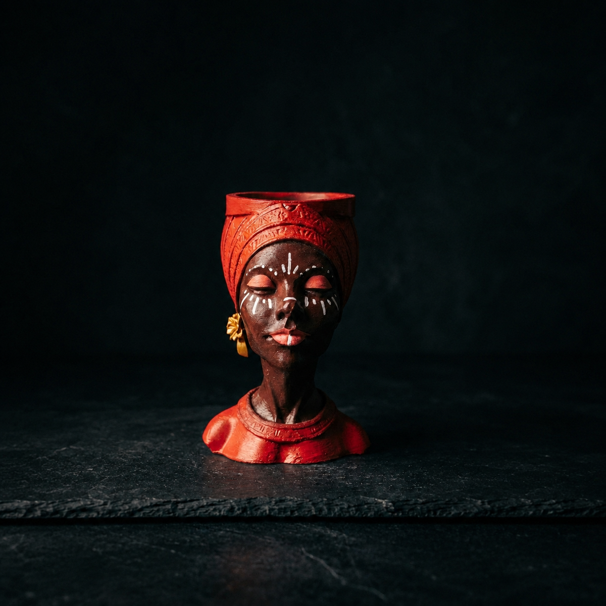 Unplanted red Afro woman head planter shown front-on