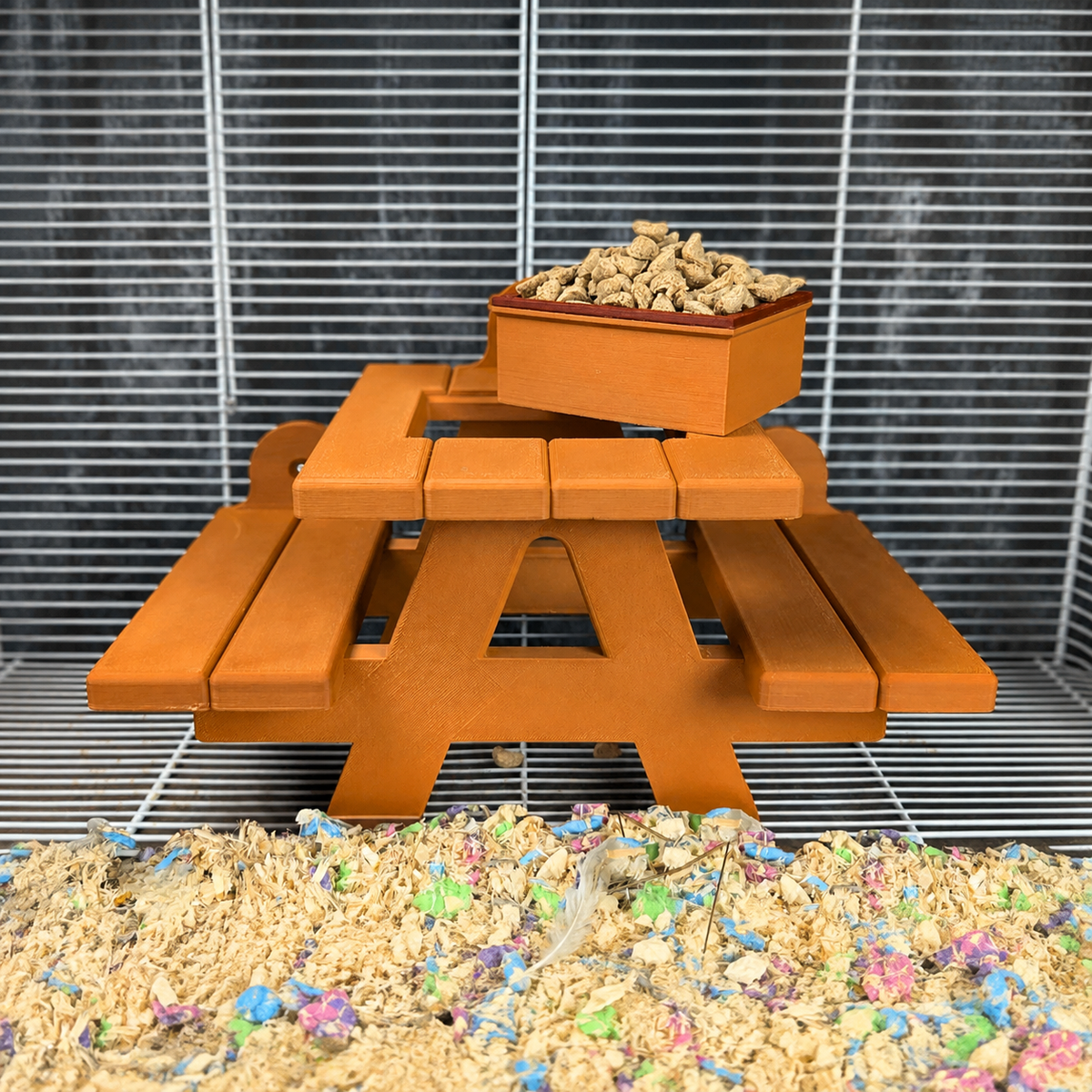 Front view of the rat picnic bench food bowl attached to cage bars