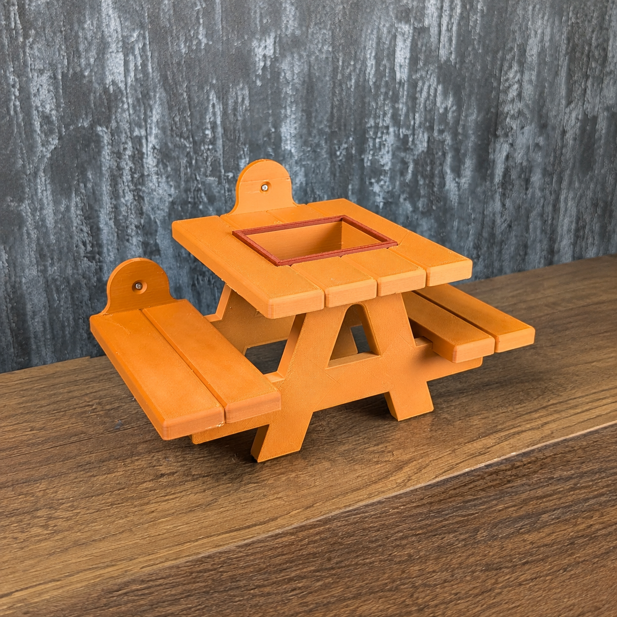 Orange rat picnic bench shown without the removable food bowl