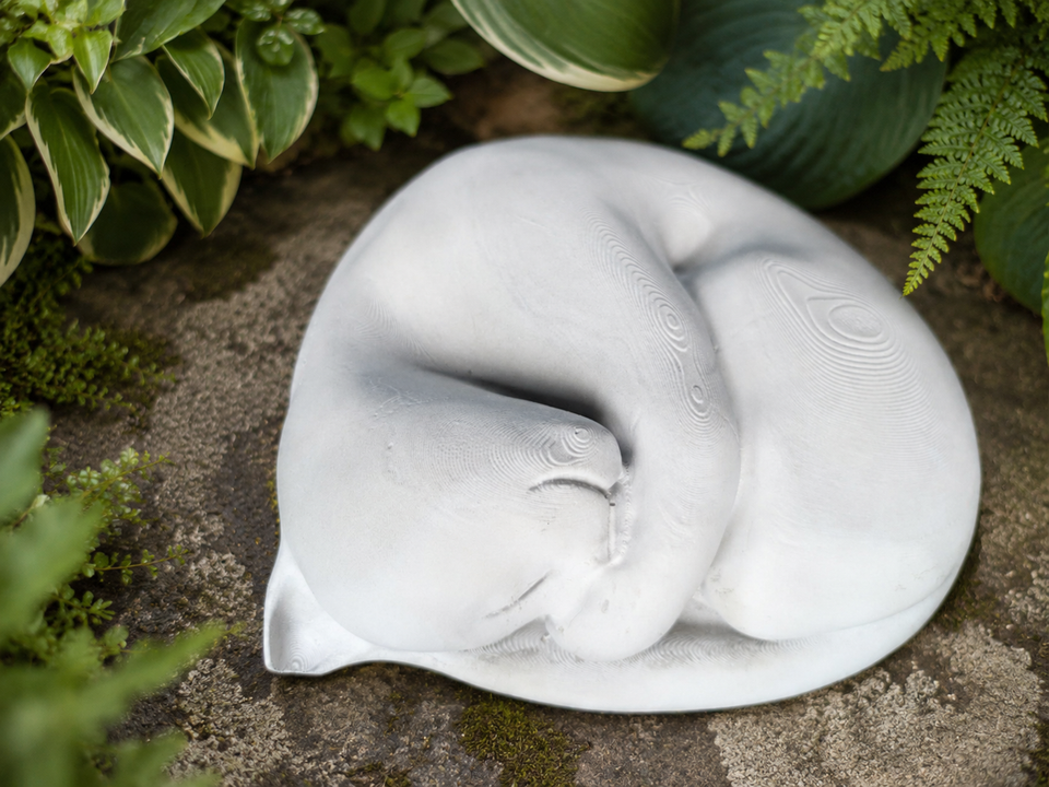 Sleeping Cat Garden Statue top view among garden foliage