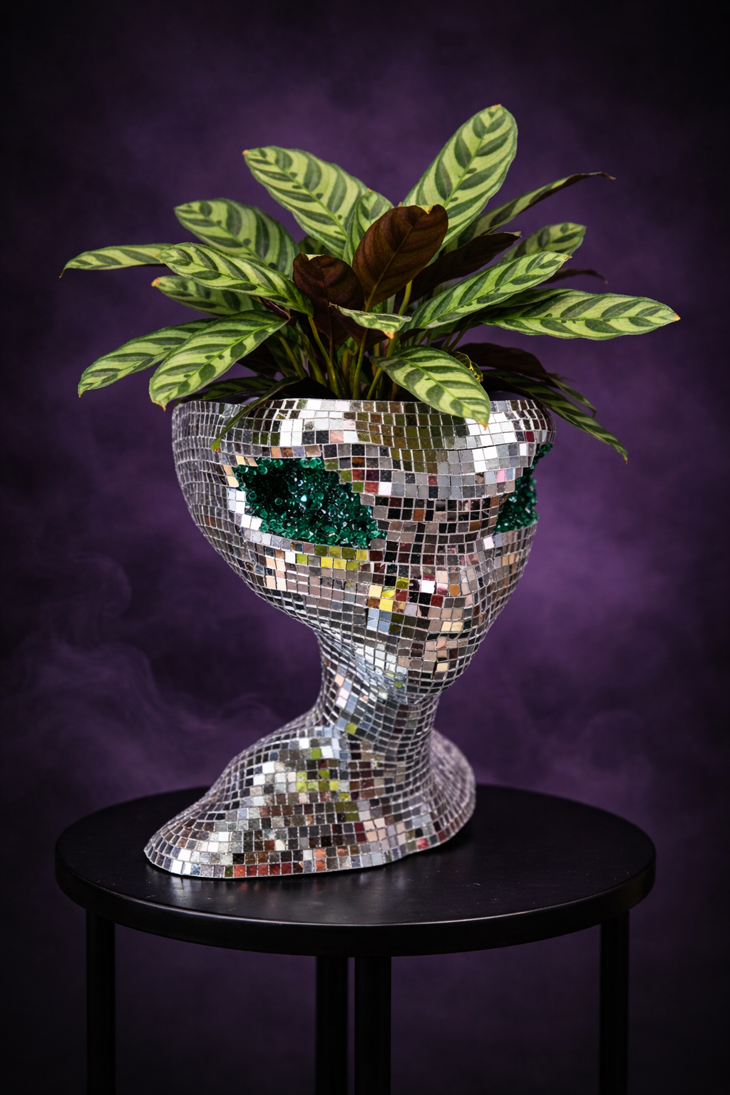 Mirror ball alien planter styled with plants in home setting