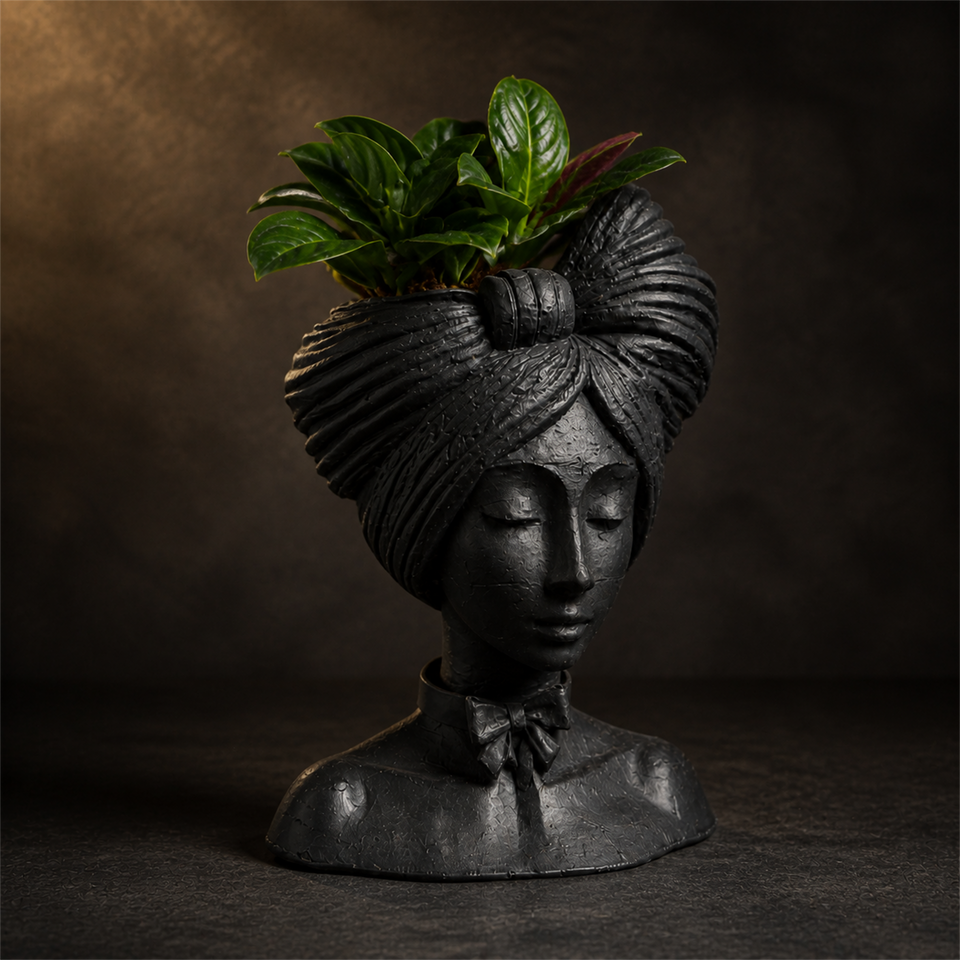 Woman head planter showing the sculpted headwrap and bow from a three-quarter angle